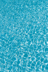 Sea surface background. Vacation resort water background. Sea beach. Summer vacation at ocean shore. Blue ocean rippled water texture reflection. Ripple water in summer pool. Holiday getaway