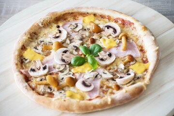 Whole Homemade Pizza on Wooden Table with Ingredients Background. National Pizza Day, La Giornata Mondiale della Pizza, World Pizza Day. Tasty, Food, Fast Food, Hunger.
