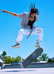 Skateboard, park and black man with jump in air for fun trick, practice and energy in summer. Blue...