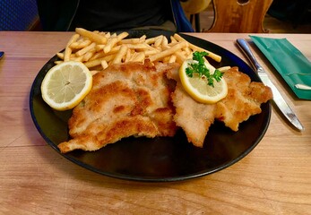 Schnitzel and chips with salad