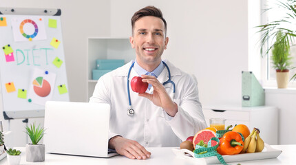Portrait of male nutritionist in his office