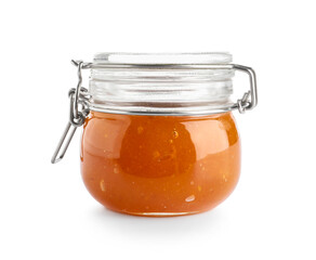 Jar with sweet apricot jam on white background