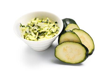 Bowl with slices of fresh green zucchini on white background