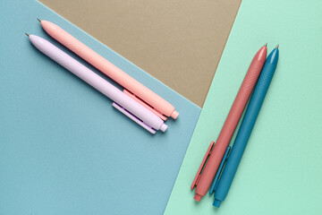 Pens on colorful background. Top view