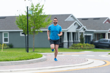 Man running with energy. Sport lifestyle. Sportsman running in the morning. Sport man training outdoor in neighborhood. Healthy lifestyle with daily fitness. Fitness and sport. Warm-up exercises