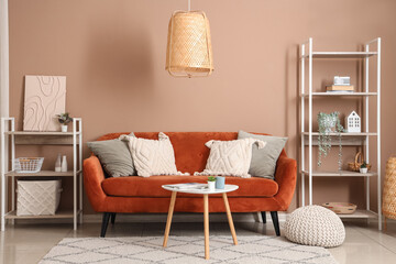 Interior of stylish living room with brown sofa and coffee table near beige wall