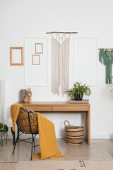 Interior of cozy office with workplace and wall tapestries