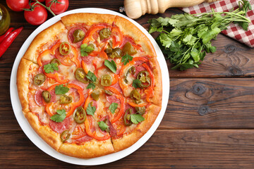 Delicious pizza Diablo and ingredients on wooden table, flat lay. Space for text