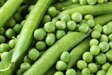 Many fresh green pods and peas as background, closeup