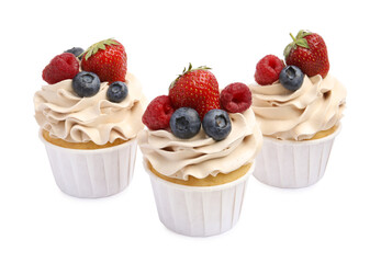 Tasty cupcakes with different berries isolated on white