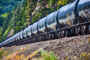 Long Freight Train in Rugged Mountainside from Low Side Perspective