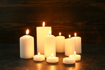 Burning candles on wooden background. Day of Remembrance