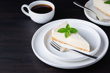 Tasty Cheesecake With Coffee on a dark wooden table