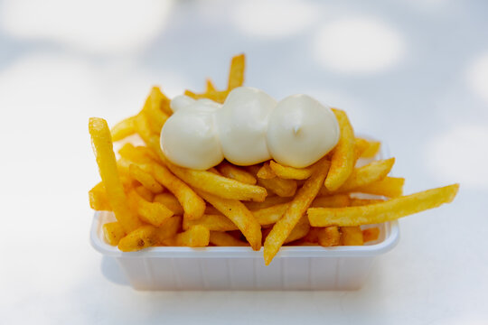 Selective focus of french fries in white plastic box on the table, Friet or Patat served with mayonnaise, Fritessaus or frietsaus is a Dutch accompaniment to French fries, Served popularly nationwide.