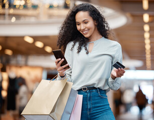 Happy woman, shopping bags and phone with credit card at mall for easy payment or ecommerce. Female...