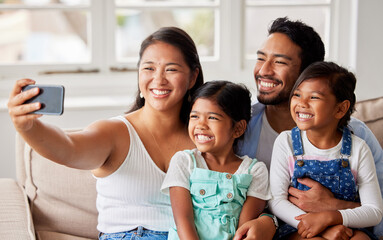 Obraz premium Selfie, happy and mom, dad and children on sofa for social media, profile picture and online post. Family, love and mother, father and kids take photo for bonding, weekend and relax in living room