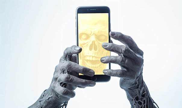 A zombie holds a phone in his hand a Halloween concept