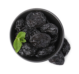 Tasty dried plums (prunes) and mint leaves in bowl on white background, top view