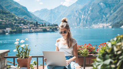 Obraz premium Young White female Entrepreneur working on a laptop and enjoying work by the lakeside, Digital Nomad Working Remotely. 