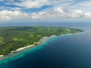 Tropical landscape of Island with beach surrounded by corals and blue sea. Carabao Island, Romblon....