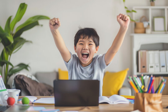 Child doing his schoolwork at home, there are books and notes to study for primary school, diverse kids on computer