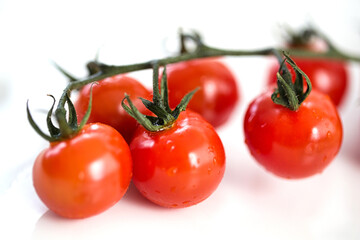 Close-up ripe cherry tomatoes still attached to the vine