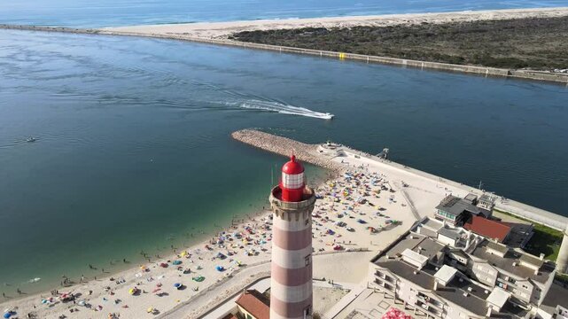 Aerial video of the town and beach and lighthouse in Praia da Barra Aveiro Portugal