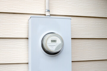Electric meter installed outside of a house. Electricity meter mounted on outdoor wall