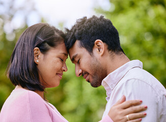 Obraz premium Couple, eyes closed and forehead or happy in nature, smile and commitment together for relationship bonding. Love, romance and married people in park, trust and support with partners for intimacy