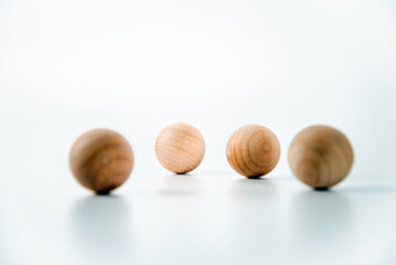 Round wooden balls, spaced apart, app stack on white background, Copy Space