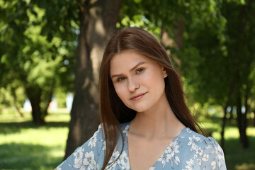 Portrait of beautiful woman in summer park