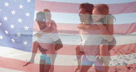Image of flag of usa over happy diverse men carrying women piggyback on beach in summer