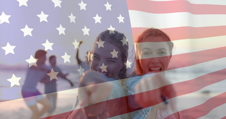 Image of flag of usa over happy diverse women on beach in summer