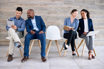 Fototapeta premium Recruitment, chair and row of people with interview, discussion and notes in book, laptop or tablet. Hiring, diversity and candidate group ready with smile, work opportunity and queue for vacancy