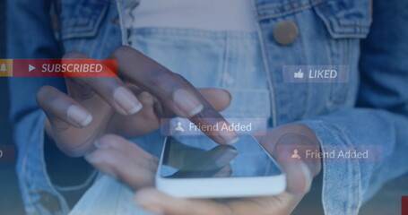 Fototapeta premium Image of social media icons floating against mid section of woman using smartphone