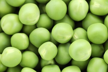 Fresh raw green peas as background, top view