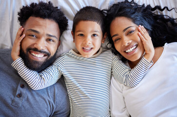 Above family, boy and happy portrait on bed for morning peace, bonding time and relationship trust in home. Parents, young child and smile together on mattress for wake up, relax and love support