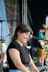 Female performer on stage. Portrait of woman at a microphone.