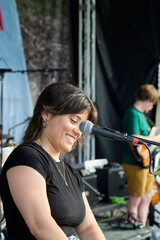 Female performer on stage. Portrait of woman at a microphone.