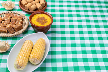 Typical brazilian june festival food over plaid fabric with copy space. Festa junina