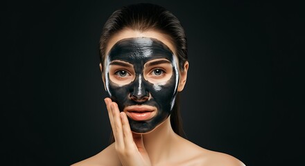 Woman with charcoal face mask. Skin care concept.