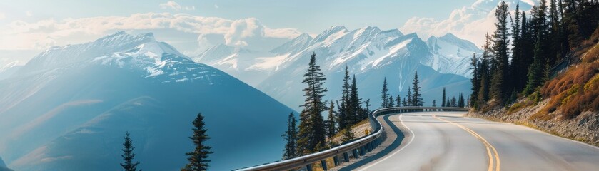 A winding mountain road with a guardrail, surrounded by tall evergreen trees, leading towards snow-capped peaks under a clear blue sky with scattered clouds.
