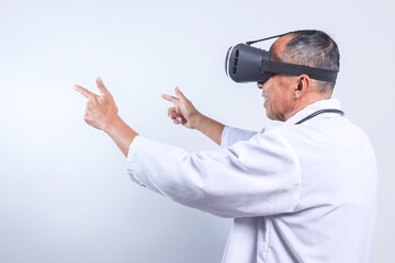 Professional Senior Male Doctor Pointing To Leftside Wearing Virtual Reality Glasses Isolated On White Background