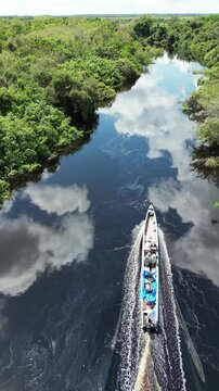 Aerial view of a small boat in the Amazon rainforest, South America