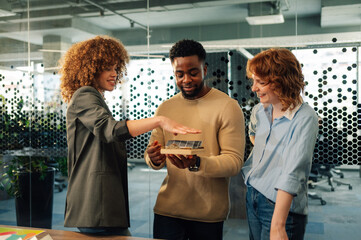 Interracial team of ecology experts developing solar energy at office.