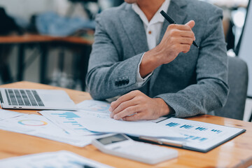 Young Businesspeople Working with Laptop in Modern Office. Office Workers at Work. Communication and Discussion at Work Concepts. Business Concept. Businessman and Businesswoman Concepts.