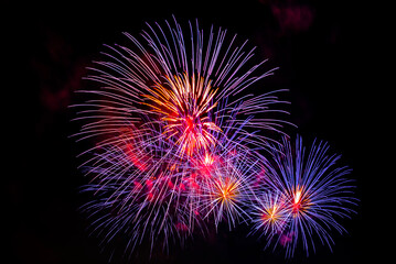 Fototapeta premium Montreal, Canada - June 27 2024: Fire works show with quarter moon in background at La Ronde in Montreal