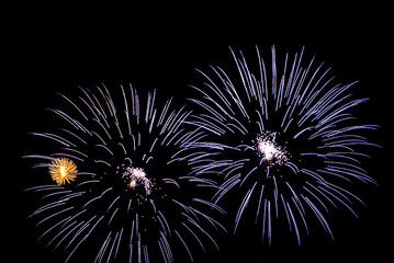 Montreal, Canada - June 27 2024: Fire works show with quarter moon in background at La Ronde in Montreal