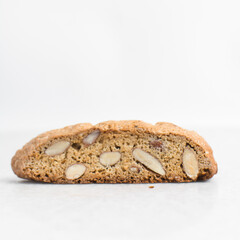 almond biscotti on white marble countertop, almond cantucci cookies on a white board, slices of biscotti cookies or twice baked cookies