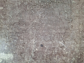 The background is made of an old worn, gray-black surface